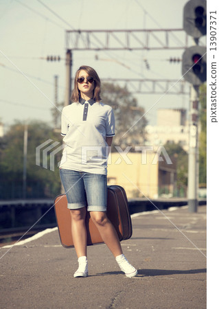 Young fashion girl with suitcase at railways. Young fashion girl with suitcase at railways. 13907371