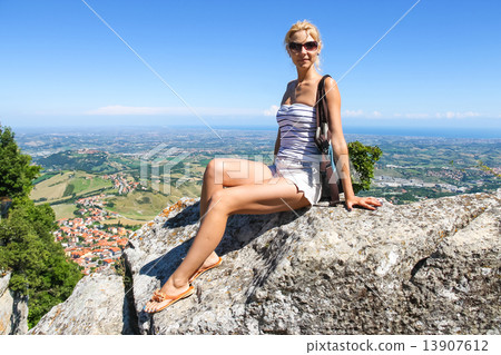 Attractive girl sitting on a stone in the fortress of San Marino 13907612