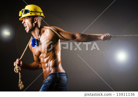 Nude builder pulling rope in darkness Nude builder pulling rope in darkness 13911136