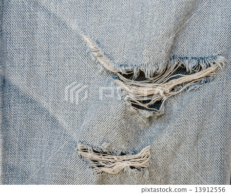 jean texture with a hole and threads showing 13912556