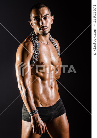 Muscular man with chain on black background Muscular man with chain on black background 13913671