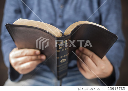 Man reading the holy bible Man reading the holy bible 13917785