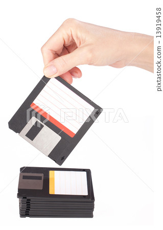 female hand takes a floppy disk 13919458