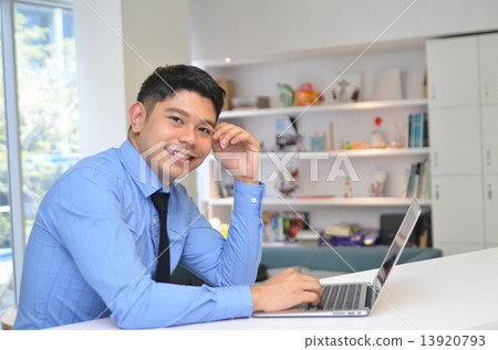 Asian business man using laptop computer in the office 13920793