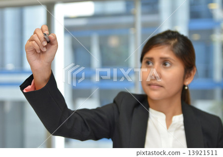 India business woman writing with pen in the air India business woman writing with pen in the air 13921511