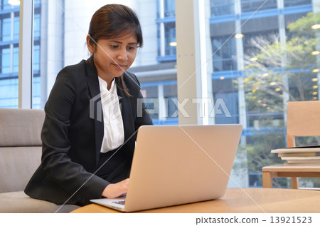 Young indian businesswoman is using laptop computer. Young indian businesswoman is using laptop computer. 13921523