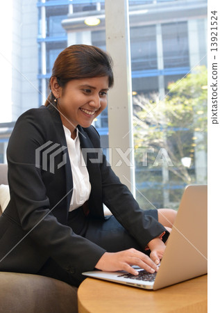 Young indian businesswoman is using laptop computer. 13921524