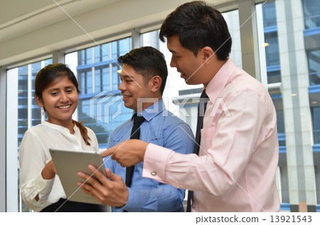 Group of business people using tablet computer in office 13921543