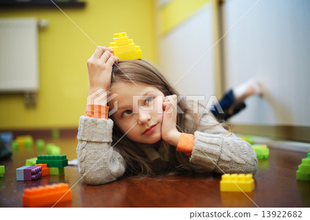 Happy beautiful girl plays with blocks 13922682