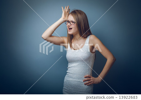 European appearance blonde girl with glasses put her hand to her European appearance blonde girl with glasses put her hand to her 13922683