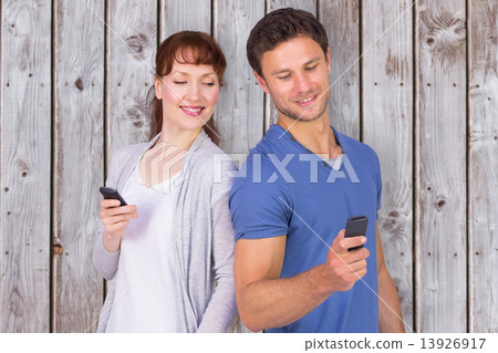 Composite image of couple both making phone calls 13926917