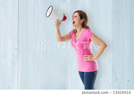 Composite image of angry woman with megaphone 13926918
