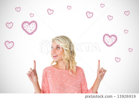 Composite image of pretty blonde smiling and pointing up Composite image of pretty blonde smiling and pointing up 13926919