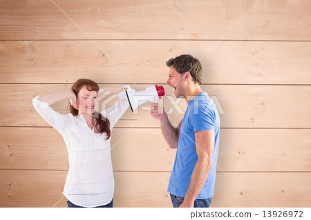 Composite image of man shouting through a megaphone 13926972