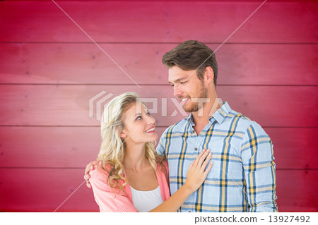 Composite image of attractive young couple smiling at each other 13927492