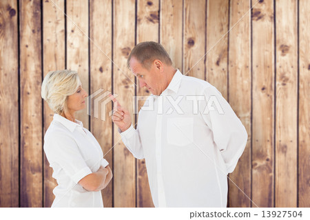Composite image of angry man pointing at his partner Composite image of angry man pointing at his partner 13927504