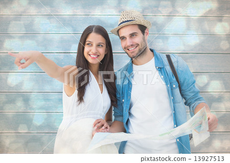 Composite image of happy hipster couple looking at map Composite image of happy hipster couple looking at map 13927513