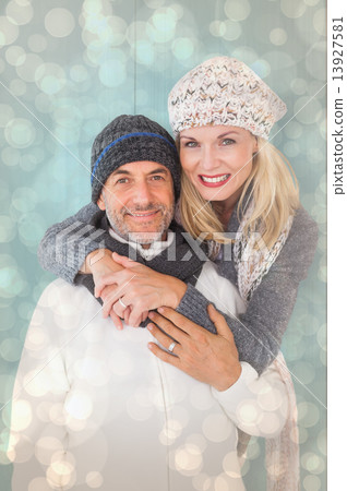 Composite image of happy couple in winter fashion embracing Composite image of happy couple in winter fashion embracing 13927581