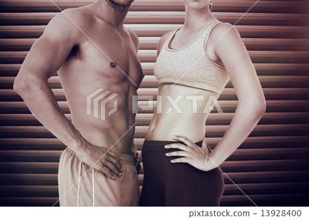 Composite image of mid section of a fit young couple 13928400