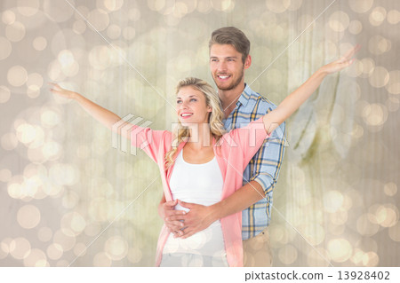 Composite image of attractive young couple smiling and embracing 13928402