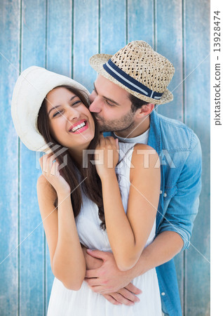 Composite image of happy hipster couple hugging and smiling Composite image of happy hipster couple hugging and smiling 13928474