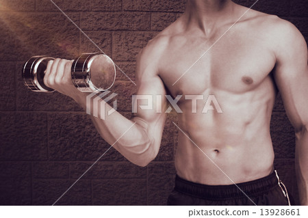 Composite image of fit shirtless man lifting dumbbell 13928661