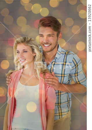 Composite image of attractive young couple smiling together 13928662