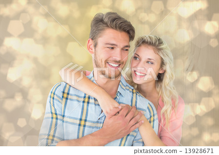 Composite image of attractive couple embracing and smiling Composite image of attractive couple embracing and smiling 13928671