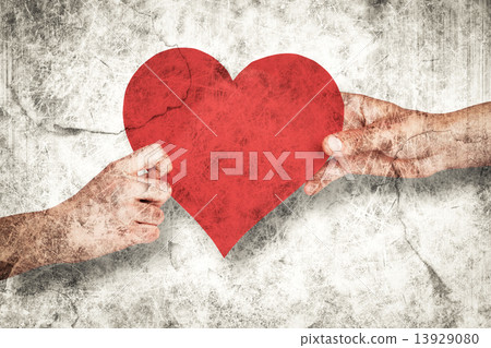 Composite image of hands holding red heart 13929080