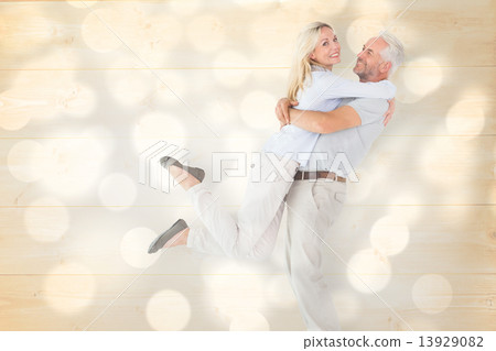 Composite image of man picking up his partner while hugging here Composite image of man picking up his partner while hugging here 13929082