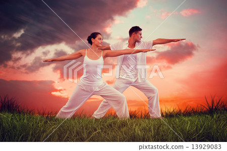 Composite image of peaceful couple in white doing yoga together 13929083