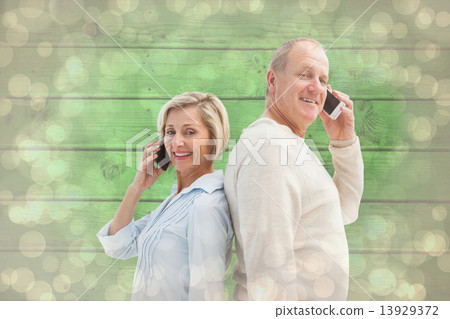 Composite image of happy mature couple talking on their phones 13929372