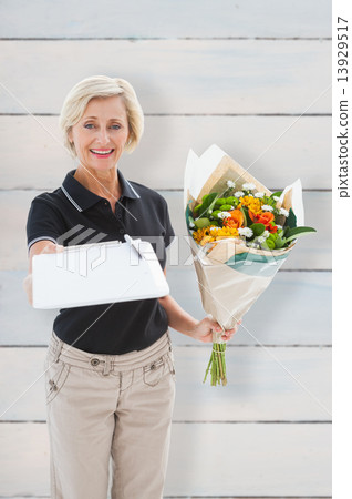 Composite image of happy flower delivery woman looking for signa 13929517