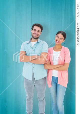 Composite image of happy couple with arms crossed Composite image of happy couple with arms crossed 13929548