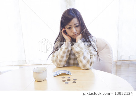 A woman who spreads money on her desk A woman who spreads money on her desk 13932124