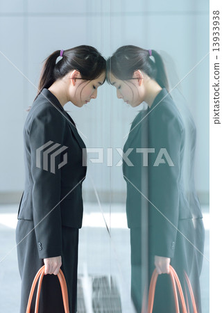 One young chinese businesswoman having a bad day at work One young chinese businesswoman having a bad day at work 13933938