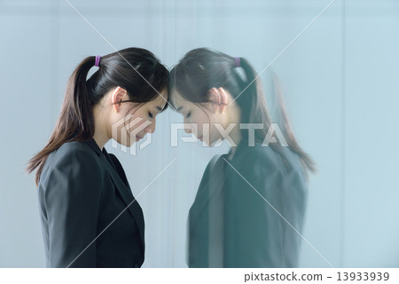 One young chinese businesswoman having a bad day at work One young chinese businesswoman having a bad day at work 13933939