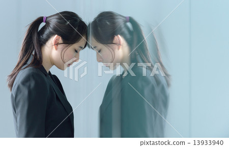 One young chinese businesswoman having a bad day at work One young chinese businesswoman having a bad day at work 13933940