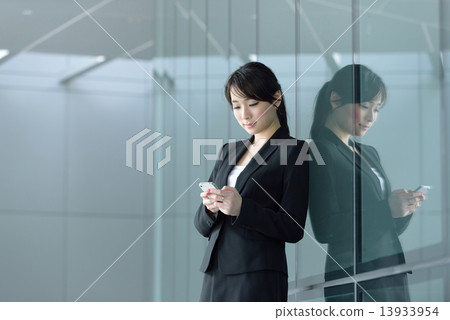 One young successful Chinese businesswoman using smart phone  13933954
