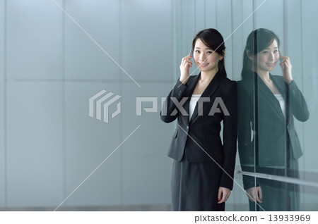 One young successful Chinese businesswoman making mobile call One young successful Chinese businesswoman making mobile call 13933969