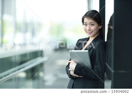One young successful Chinese businesswoman holding tablet iPad 13934002