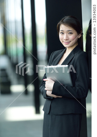 One young successful Chinese businesswoman holding tablet iPad 13934003