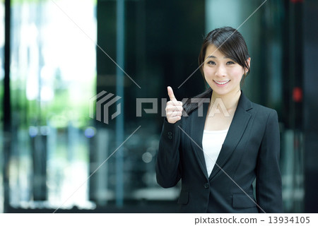 One young successful Chinese businesswoman giving 1 thumbs up 13934105