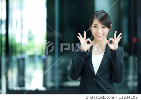 One young successful Chinese businesswoman giving ok sign One young successful Chinese businesswoman giving ok sign 13934109