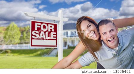 Military Couple In Front of Home with For Sale Sign 13936491
