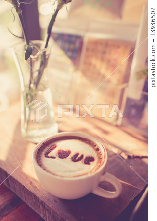 Love message on coffee cup on wooden background with vintage col 13936502