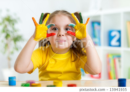cute child have fun painting her hands 13941935