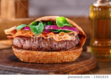 Burger close up on a cutting board on wooden background. 13942619
