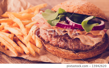 Burger and french fries close up on vintage style. Burger and french fries close up on vintage style. 13942620