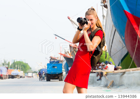 Jakarta Tourist with camera having harbor tour 13944386